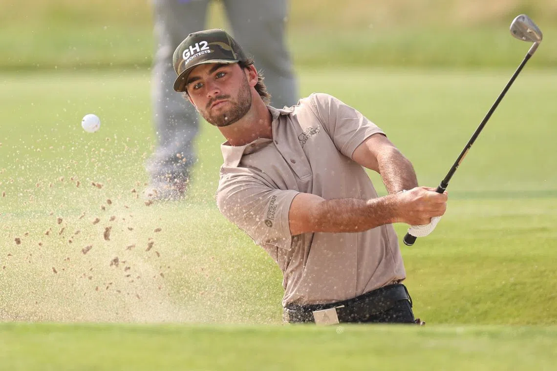 Jun 18, 2026; Southampton, New York, USA; Ryder Cowan plays a shot from the bunker on the eighteenth hole during the first round of the U.S. Open golf tournament. Mandatory Credit: Bill Streicher-Imagn Images