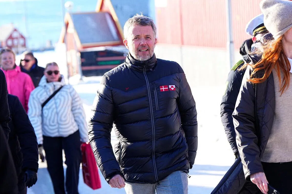 Denmark's King Frederik visiting Nuuk, Greenland, on Feb 18, wearing a black customised puffer jacket featuring the Danish and Greenlandic flag.