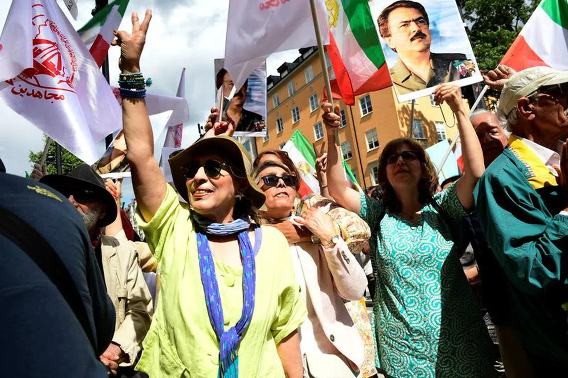 People react to the verdict of the trial of Hamid Noury, a former Iranian prosecution official accused of crimes against international law and murder in Iran in 1988, outside the Stockholm District Court in Stockholm, Sweden July 14, 2022. Noury was sentenced to a lifetime in prison. Chris Anderson/TT News Agency/via REUTERS/File Photo