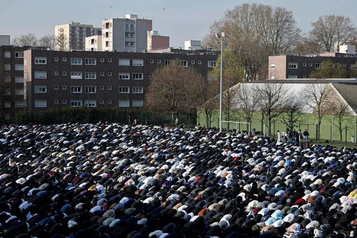 The Muslim faithful attend the Eid al-Fitr prayers, marking the end of the fasting month of Ramadan, at Stade Auguste-Delaune in Saint-Denis, near Paris.  
