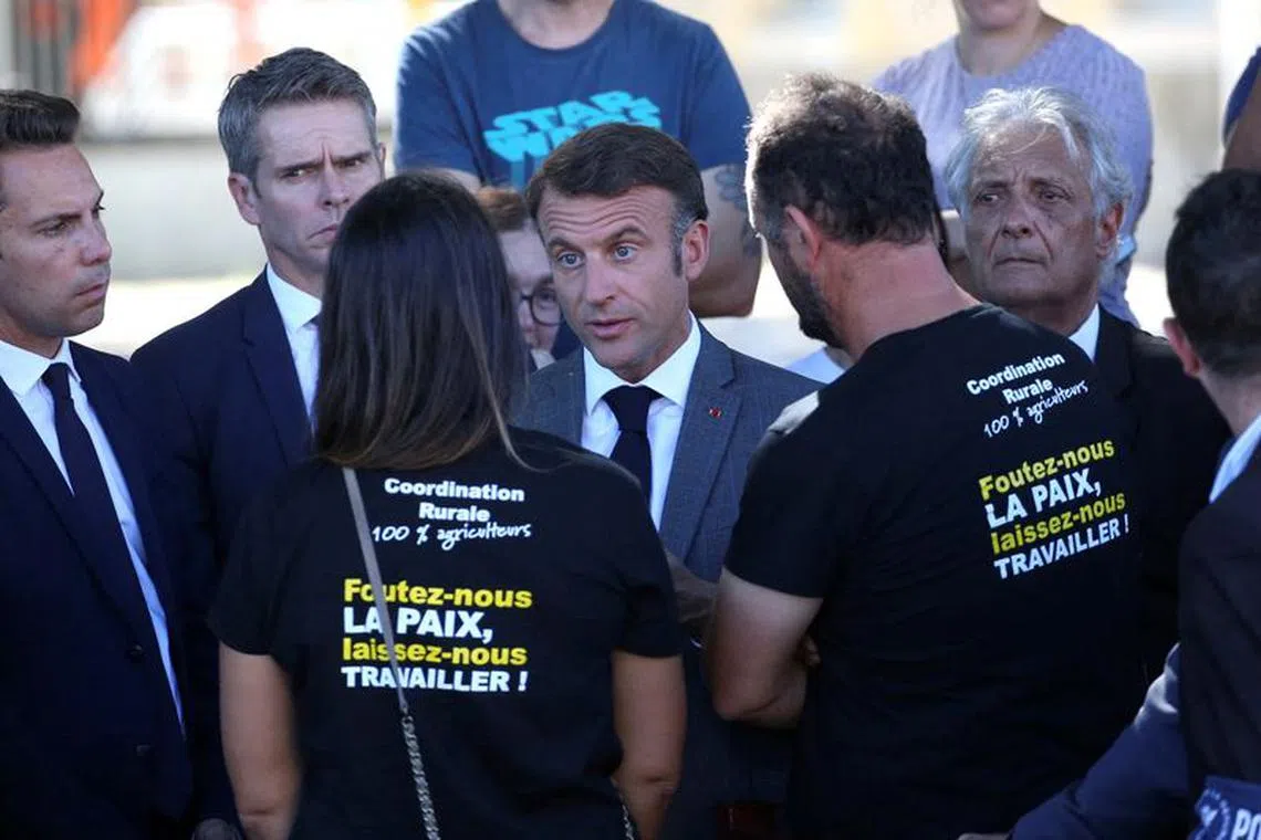 FILE PHOTO: French President Emmanuel Macron meets farmers during a walk, in Clairac, southwestern France, October 2, 2023. Bob Edme/Pool via REUTERS/File Photo