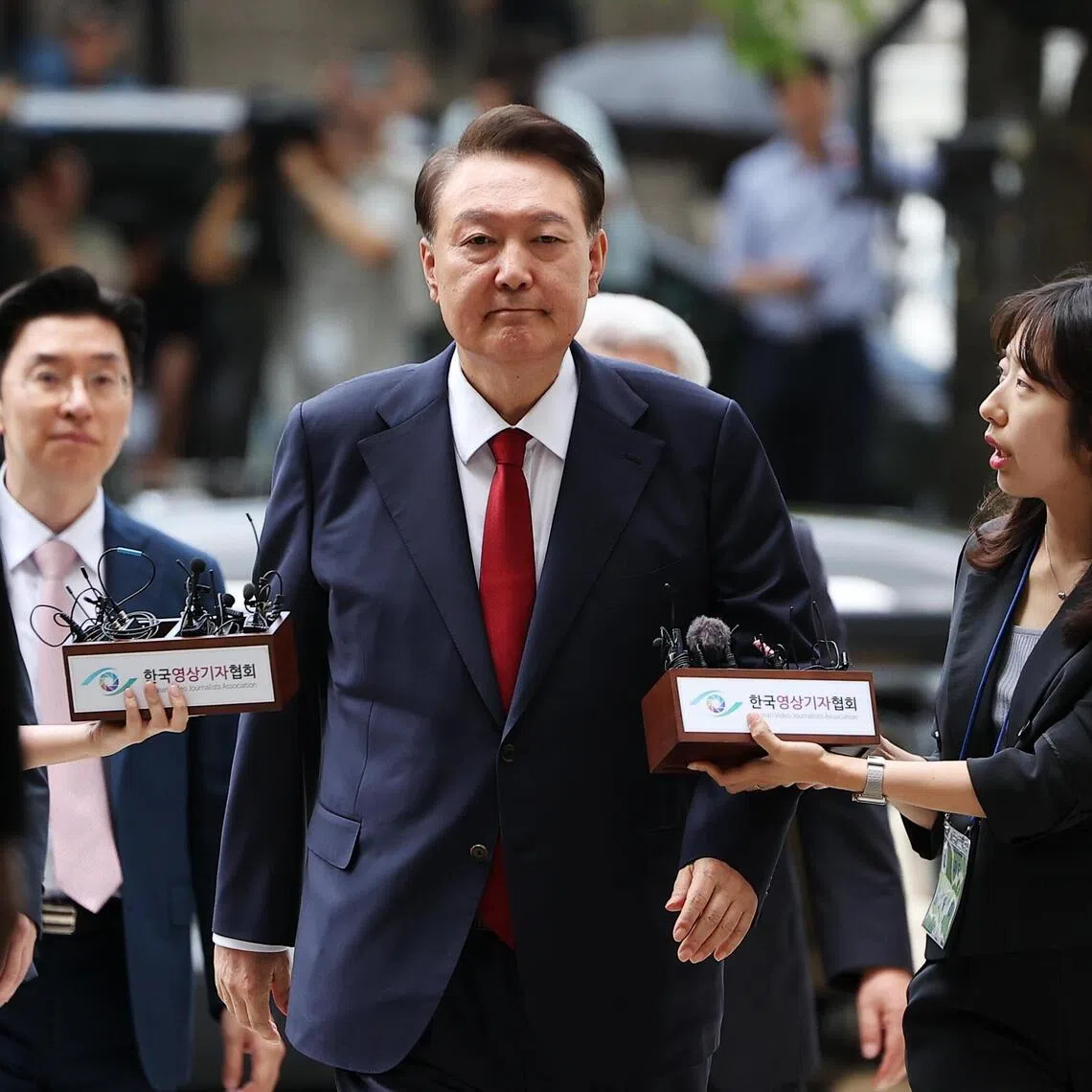 Former South Korean president Yoon Suk Yeol (centre) imposed a brief martial law in December 2024, during which he banned all political activities and placed the news media under military control.