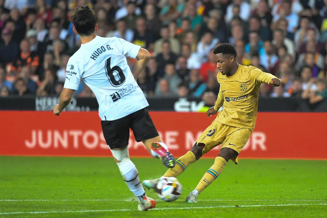 Barcelona's Spanish forward Ansu Fati (right) against
Valencia's Hugo Guillamon during a La Liga match on Oct 29, 2022.