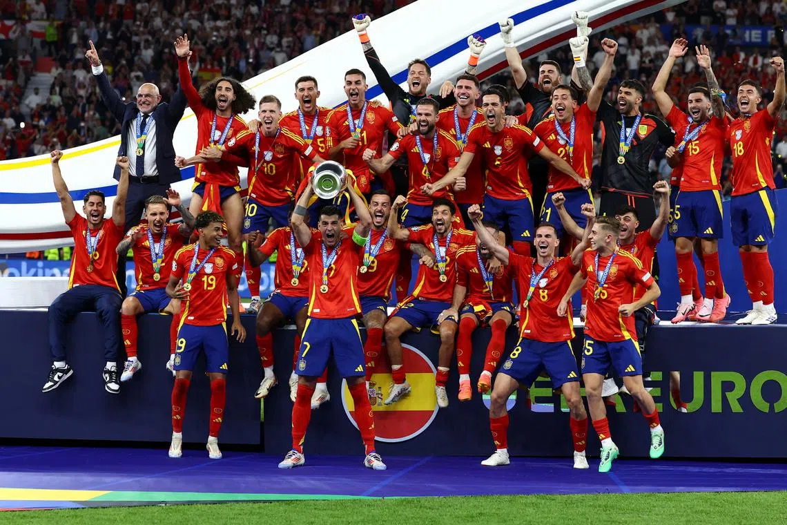 Soccer Football - Euro 2024 - Final - Spain v England - Berlin Olympiastadion, Berlin, Germany - July 14, 2024 Spain's Alvaro Morata lifts the trophy as they celebrate winning the Euro 2024 REUTERS/Lee Smith