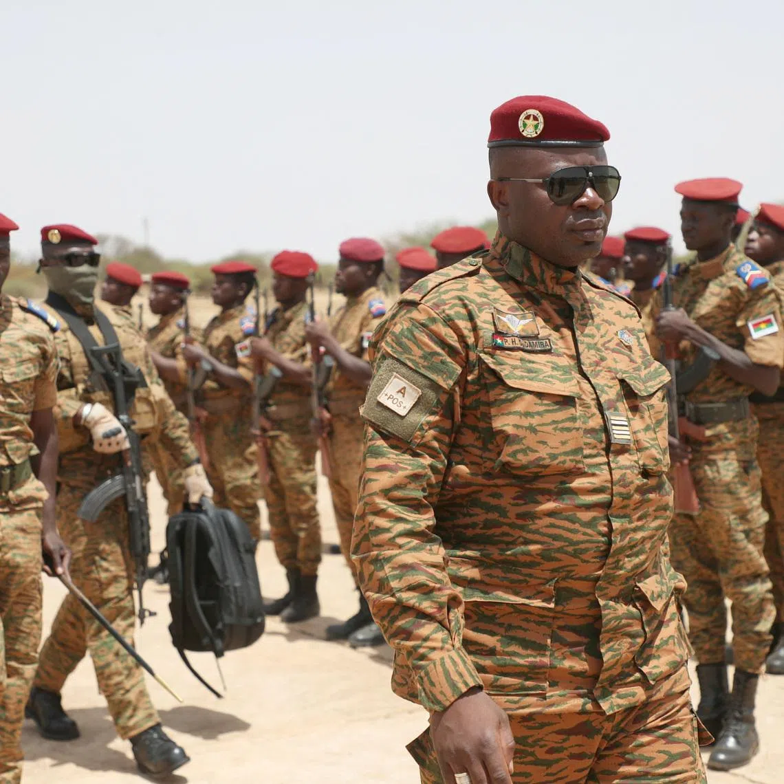 FILE PHOTO: Burkina Faso President Lieutenant Colonel Paul-Henri Damiba is welcomed by soldiers in Dori, Sahel region as he arrives to motivate his troops, after armed men killed civilians and militaries in Seytenga, at an airport in Dori, Burkina Faso June 15, 2022. Burkina Faso's Presidential Press Service/Handout via REUTERS/File Photo