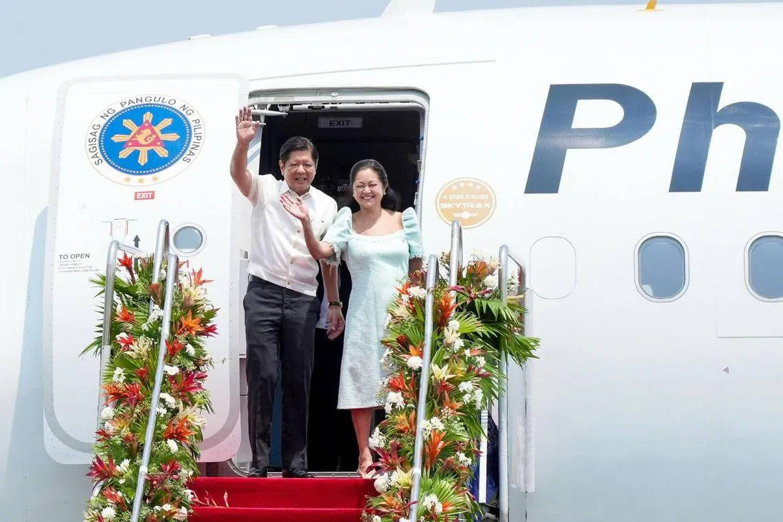 Philippine President Ferdinand Marcos Jr and First Lady Louise Araneta-Marcos waves to the crowd at the Ninoy Aquino International Airport before departing for Indonesia to attend the 42nd Asean Summit on May 9, 2023.
