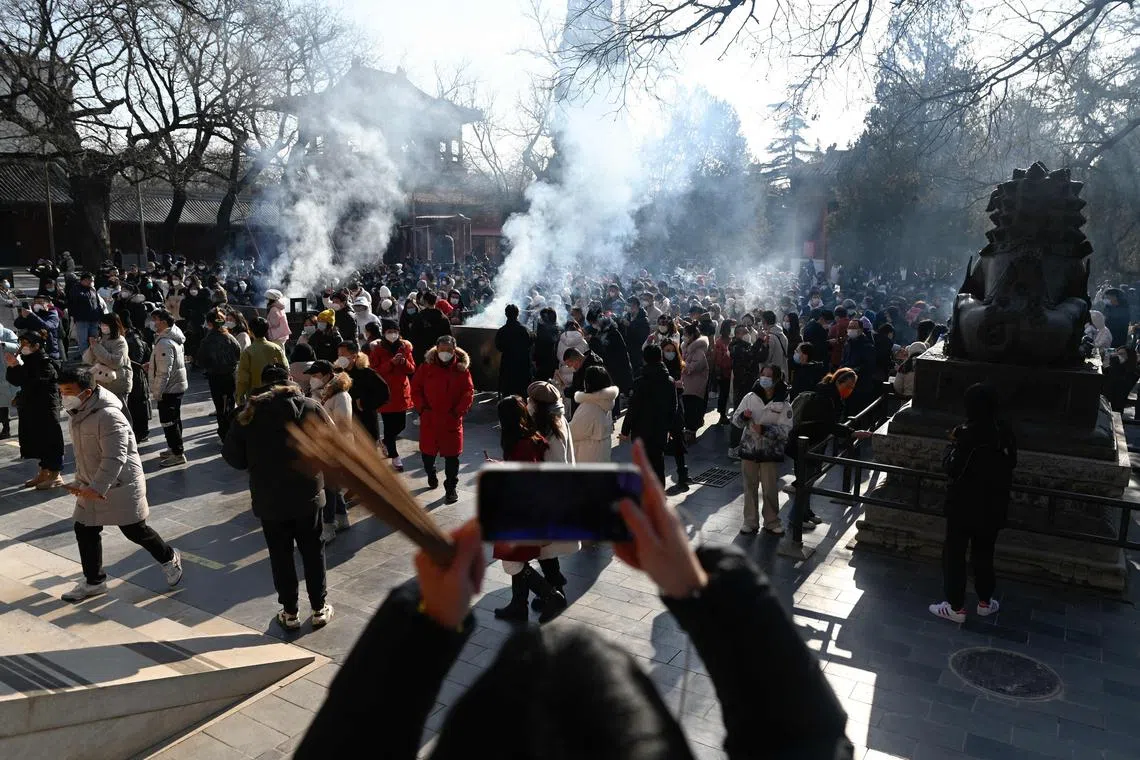 People visit Yonghe temple to pray for blessings on the first day of the new year in Beijing, on Jan 1, 2023.