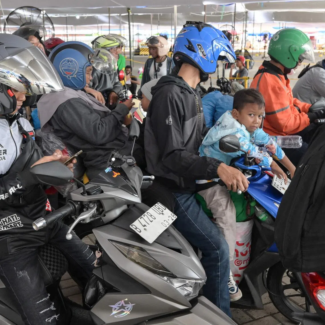 Motorcyclists wait to board the ferry at Ciwandan Port in Cilegon, Banten, on March 28.