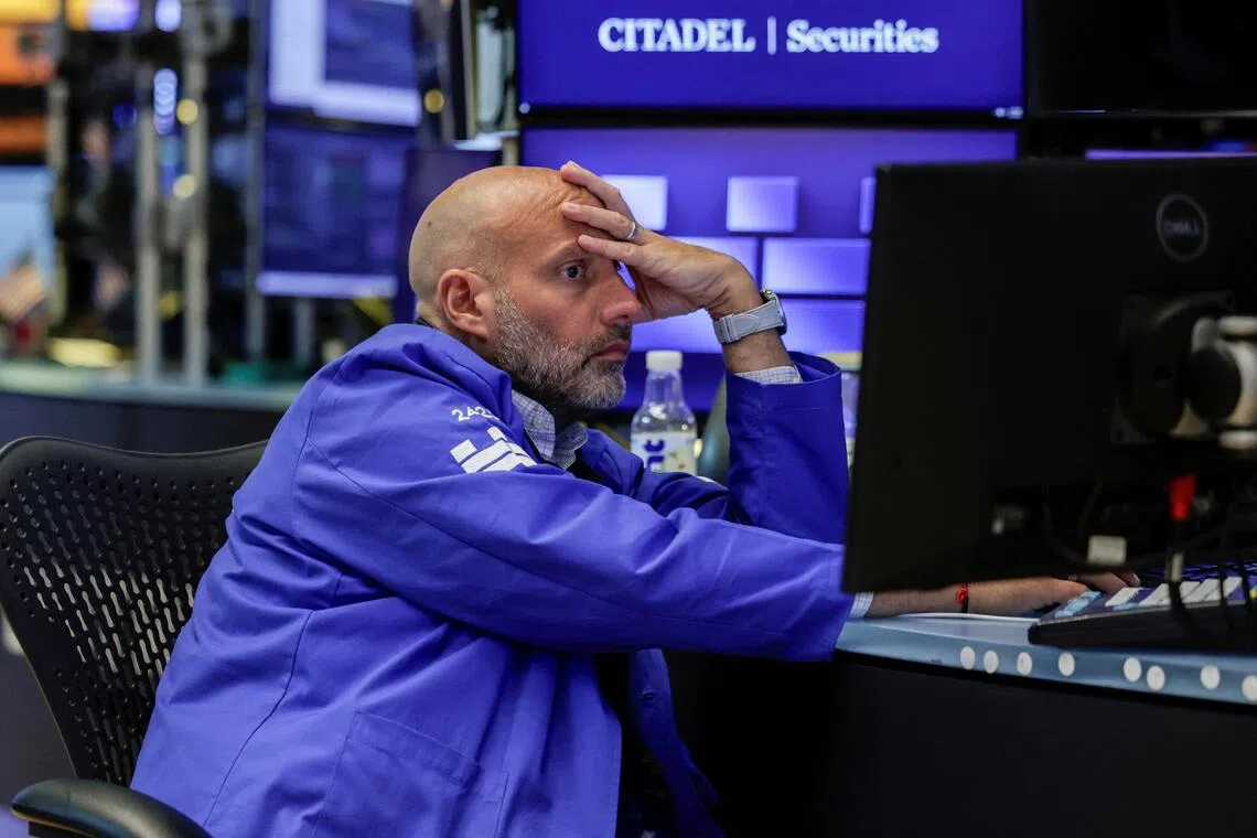 A trader working on the floor of the New York Stock Exchange, in New York City, on Aug 19.