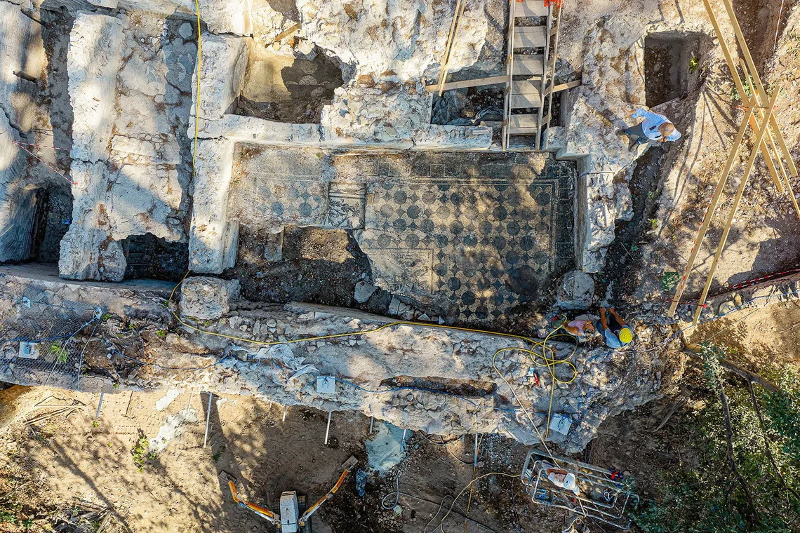 A worker cleans a mosaic floor uncovered during archaeological excavations at Villa Celimontana in Rome, Italy, in this handout image taken on July 30, 2026 and released on August 5, 2026. Rome's Special Superintendency/Handout via REUTERS.