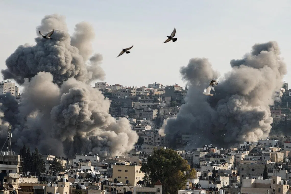 Birds fly as smoke rises during an Israeli army operation in Jenin, in the Israeli-occupied West Bank, February 2, 2025. REUTERS/Raneen Sawafta/File Photo