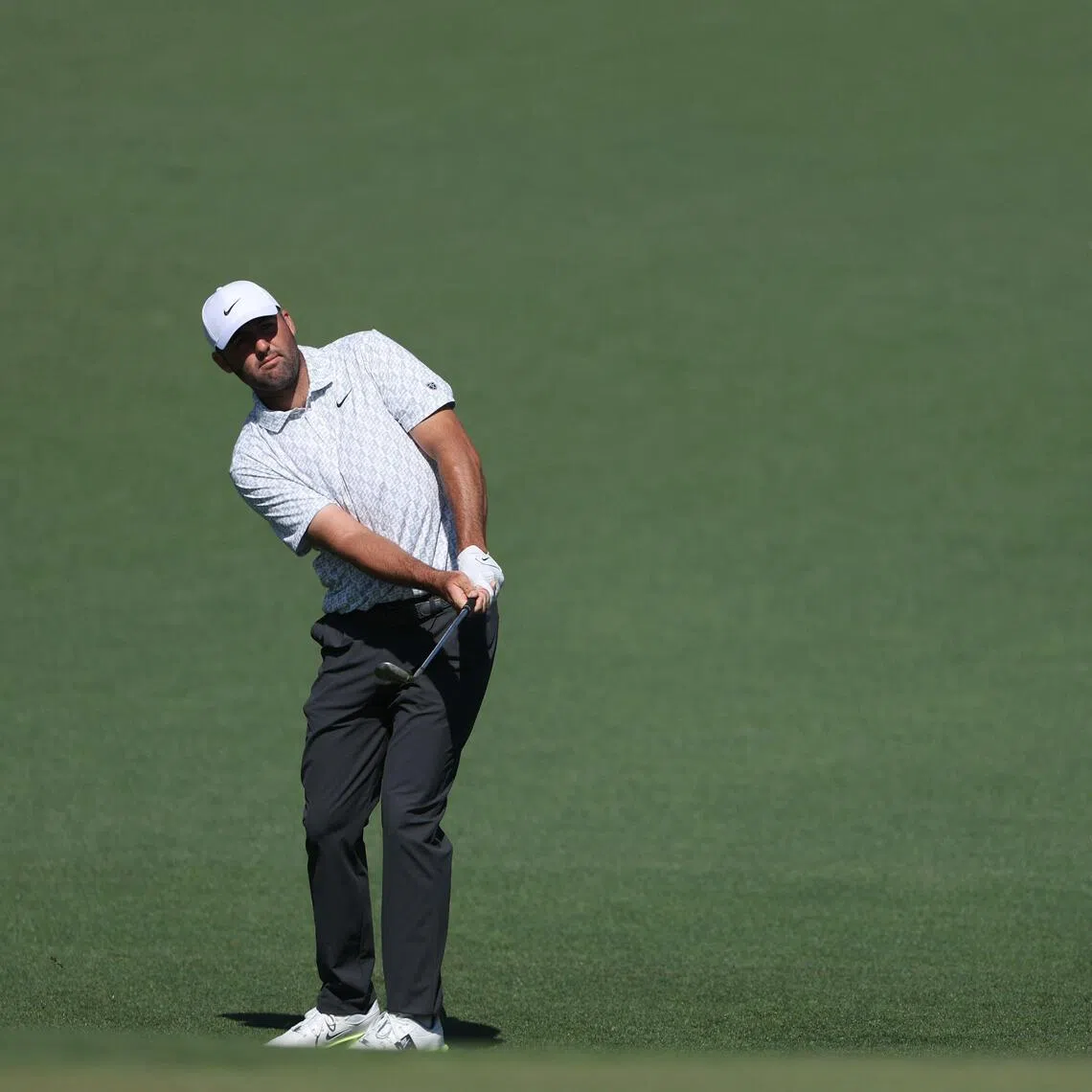 Scottie Scheffler of the United States chips onto the second green during the second round of the Masters.