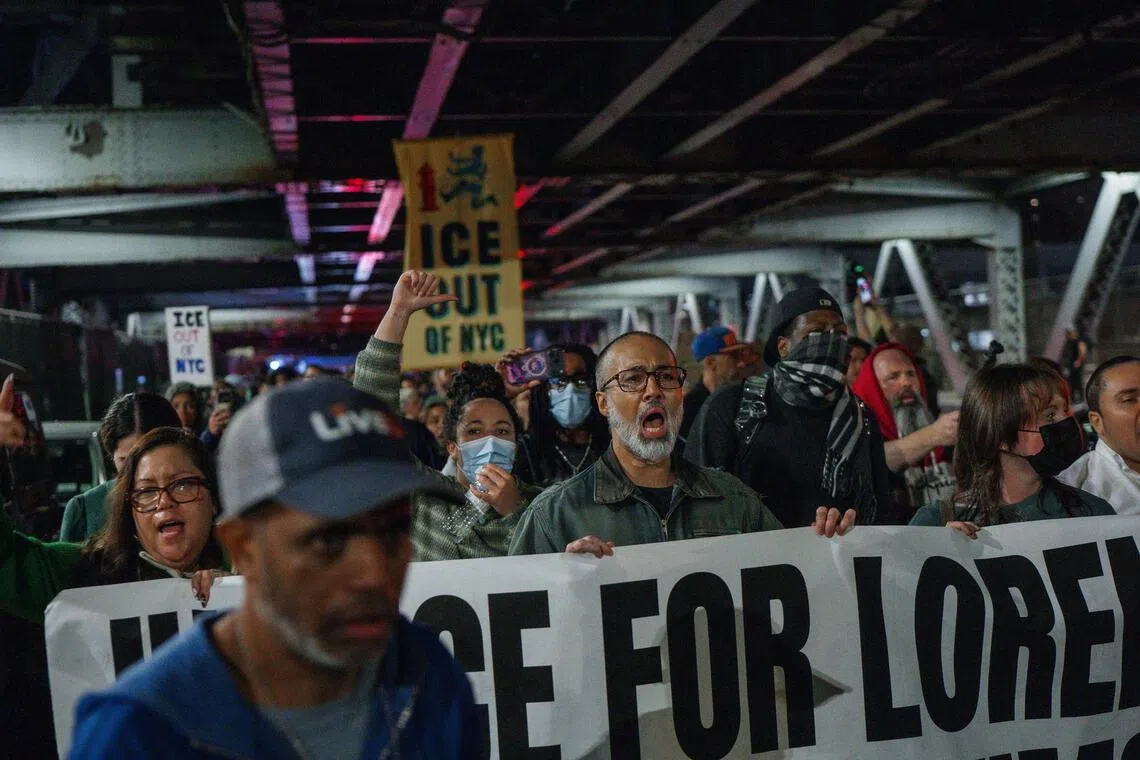 People march during a protest at the crime scene, after an ICE officer allegedly shot a man in New York, on Oct 8.
