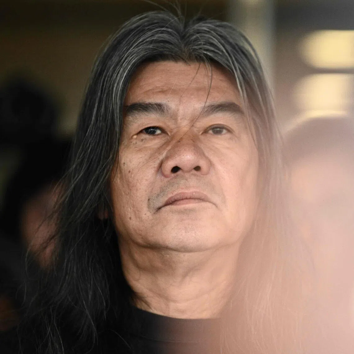 Ousted pro-democracy lawmaker Leung Kwok-hung, also known as 'Long Hair' reacts before entering the High Court to hear the sentence for his appeal.
