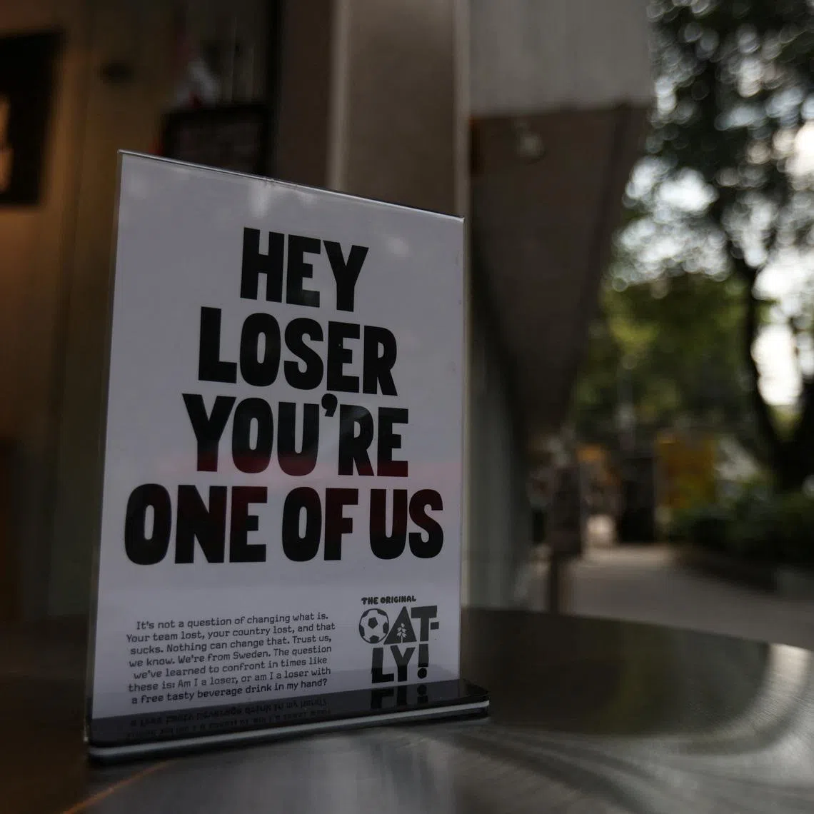 A woman walks in front of Losers Cafe, operated by Swedish dairy-alternative brand Oatly, which opened the cafe in Mexico City to console supporters of teams that lost at the 2026 World Cup with a free drink, in Mexico City, Mexico, June 26, 2026. REUTERS/Quetzalli Nicte-Ha