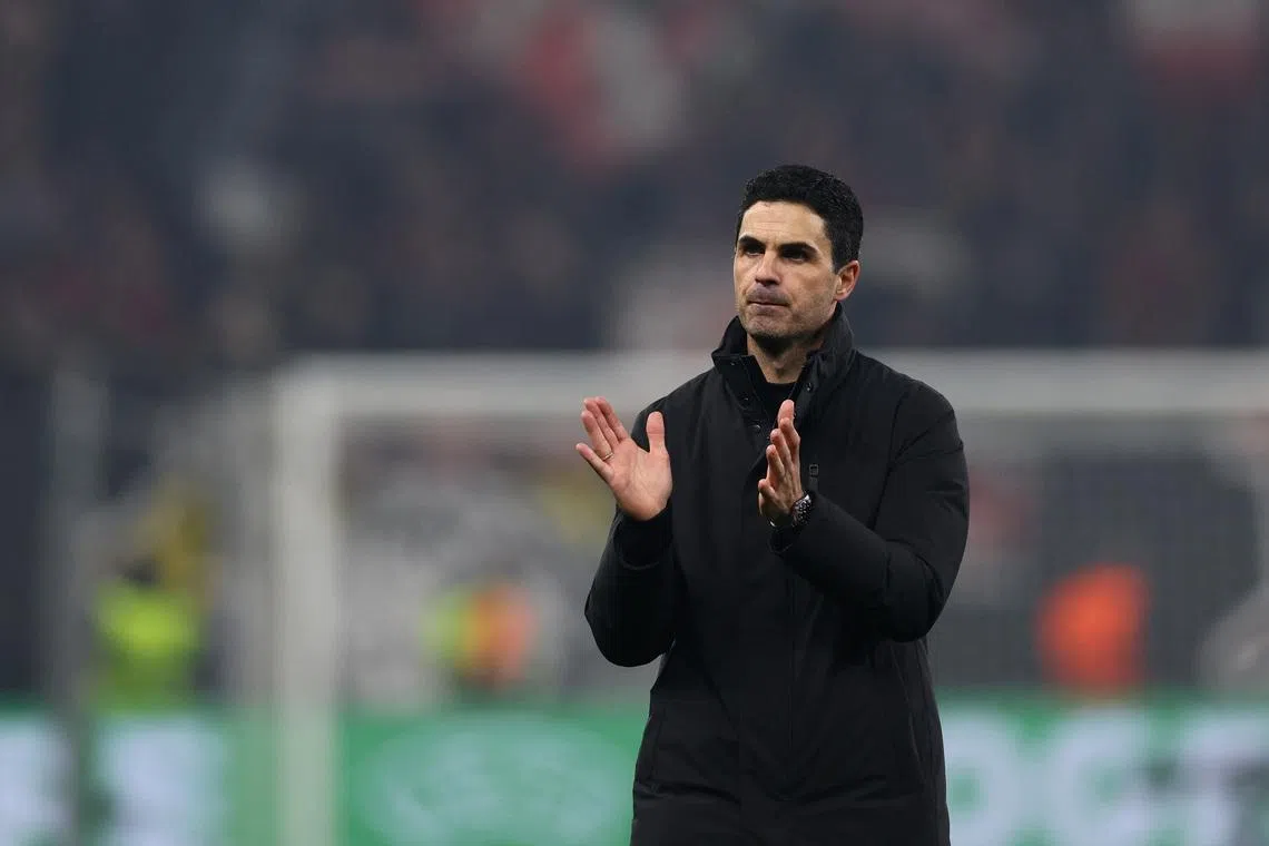 Soccer Football - UEFA Champions League - Round 16 - First Leg - Bayer Leverkusen v Arsenal - BayArena, Leverkusen, Germany - March 11, 2026 Arsenal manager Mikel Arteta applauds fans after the match REUTERS/Wolfgang Rattay