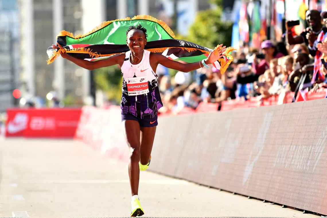 Oct 13, 2024; Chicago, IL, USA; Ruth Chepngetich of Kenya celebrates after finishing first in the women’s race, setting a new world record at 2:09:56 during the Chicago Marathon at Grant Park. Mandatory Credit: Patrick Gorski-Imagn Images