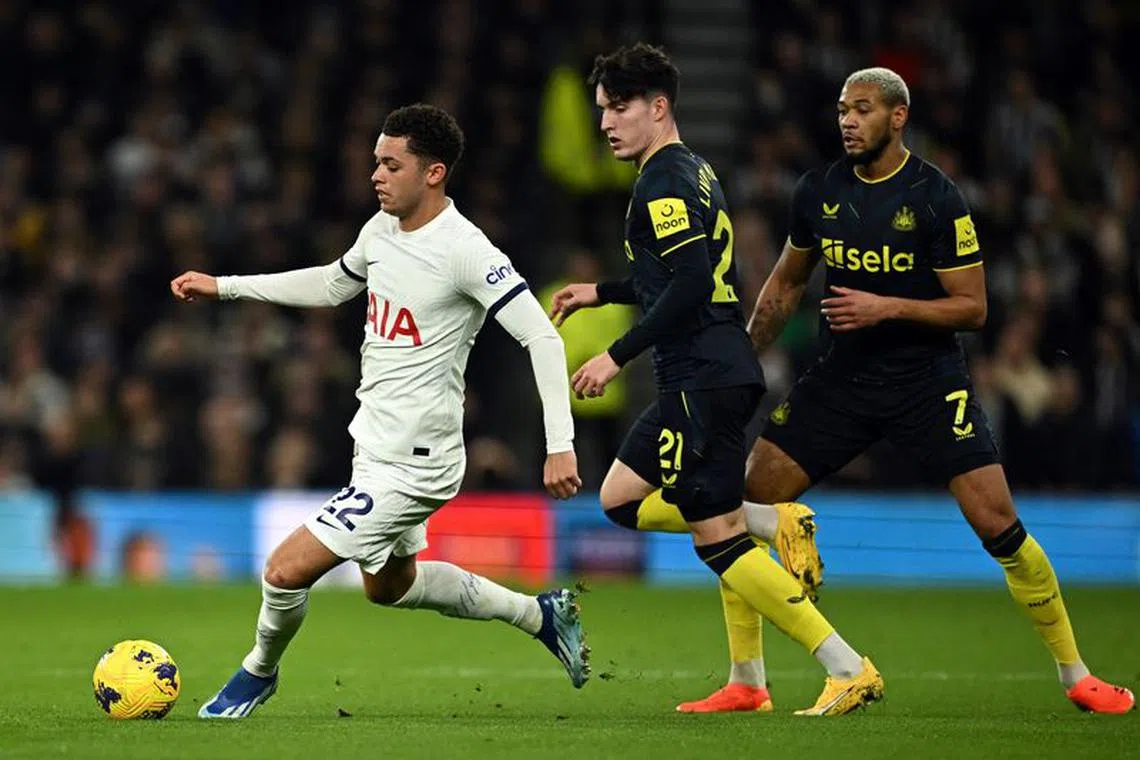 Soccer Football - Premier League - Tottenham Hotspur v Newcastle United - Tottenham Hotspur Stadium, London, Britain - December 10, 2023 Tottenham Hotspur's Brennan Johnson in action wearing a shirt without the Tottenham Hotspur crest as Newcastle United's Valentino Livramento and Joelinton look on REUTERS/Dylan Martinez/File Photo