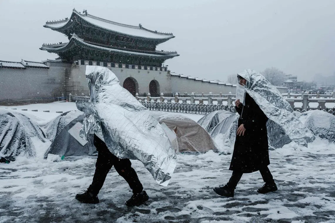 Protesters against impeached South Korean President Yoon Suk Yeol walking in front of the Gwanghwamun in Seoul, on March 18, 2025.