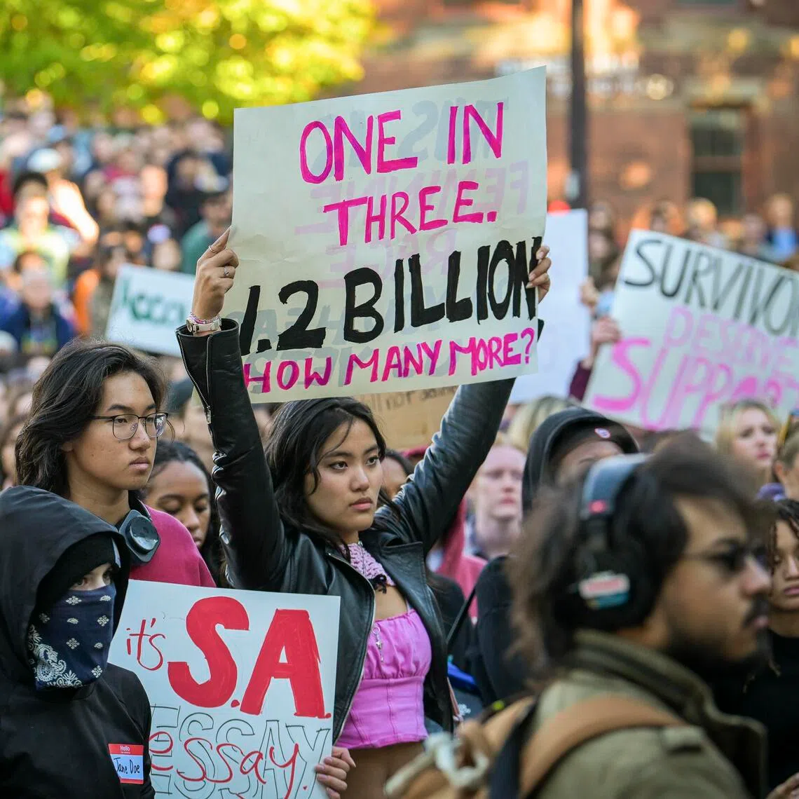 Demonstrators chant and hold signs during a protest on the Cornell campus in Ithaca, New York, on Oct 5.