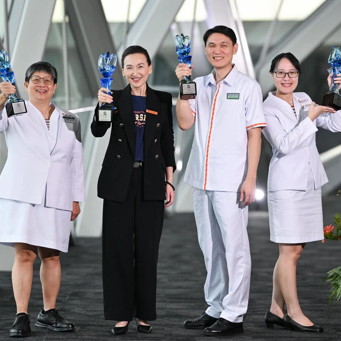 (From left) Wong Yoke Ping, Zhou Wentao, Jordan Hwang and Pham Thi Ngoc Anh with their 2026 President’s Award for Nurses.