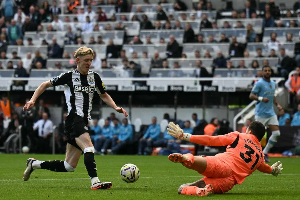 Newcastle United English midfielder Anthony Gordon trying to get past Manchester City goalkeeper Ederson, but is brought down, earning the Magpies a penalty. Gordon converts the spot-kick to earn a 1-1 English Premier League draw at St James' Park on Sept 28.