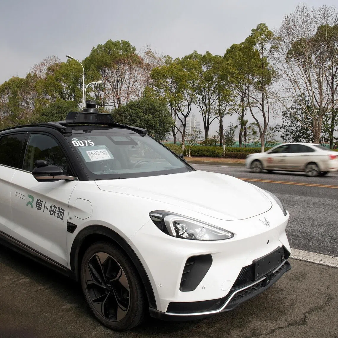 A car of Baidu's driverless robotaxi service Apollo Go on a road in Wuhan. 