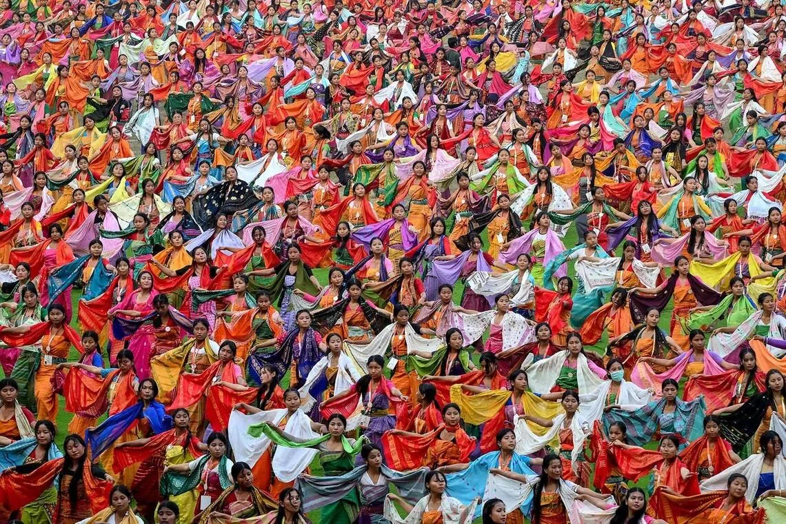 TOPSHOT - Dancers perform the 'Bagurumba' dance during a rehearsal for the upcoming Bwisagu festival, marking the Bodo New Year, at the Sarusajai Stadium in Guwahati on January 15, 2026. (Photo by Biju BORO / AFP)