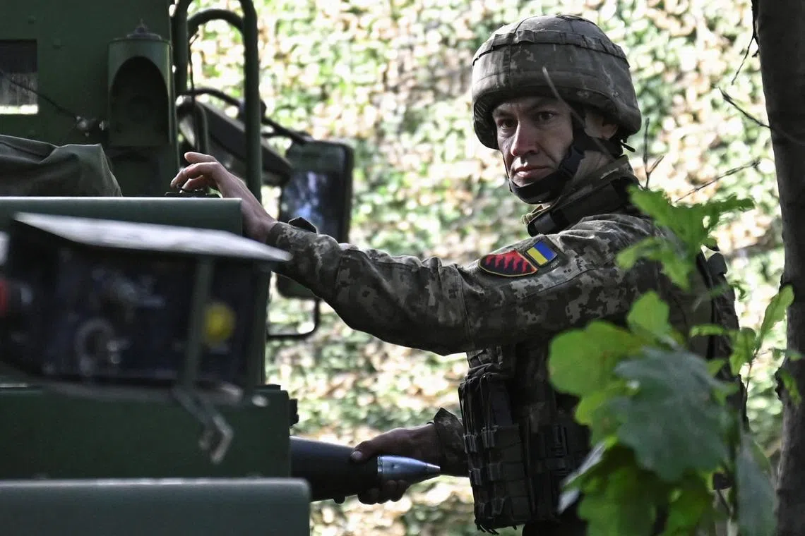 FILE PHOTO: A Ukraine serviceman holds a shell for a Caesar self-propelled howitzer before firing towards Russian troops outside the town of Pokrovsk, amid Russia's attack on Ukraine, in Donetsk region, Ukraine August 13, 2024. REUTERS/Stringer/File Photo