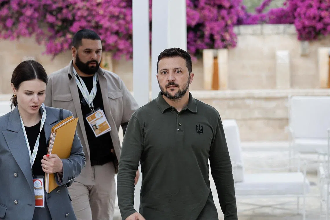 Ukrainian President Volodymyr Zelensky (centre) at the G-7 summit in Italy.