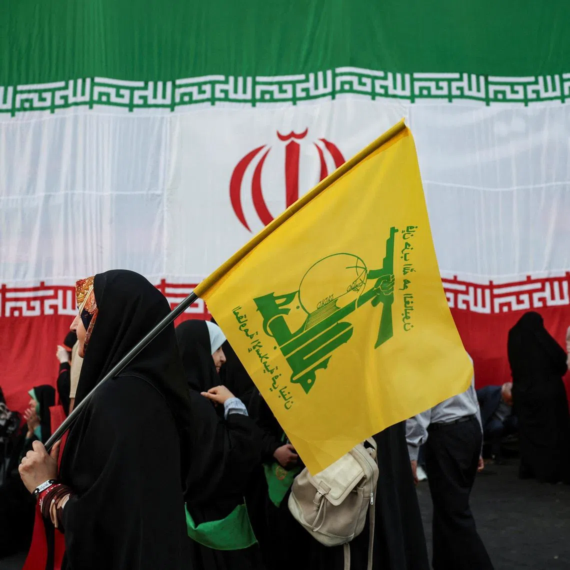 A woman holds a Hezbollah flag during a rally in support of Iran's Supreme Leader, Mojtaba Khamenei, in Tehran, Iran, June 4, 2026. Majid Asgaripour/WANA (West Asia News Agency) via REUTERS