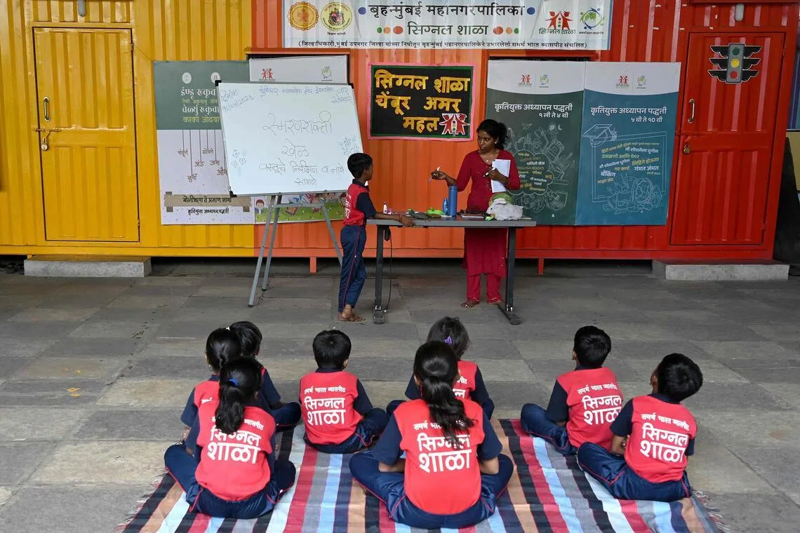 Children attend an activity class at the “Signal Shala”, or traffic signal school, under a bridge in Mumbai on May 18.