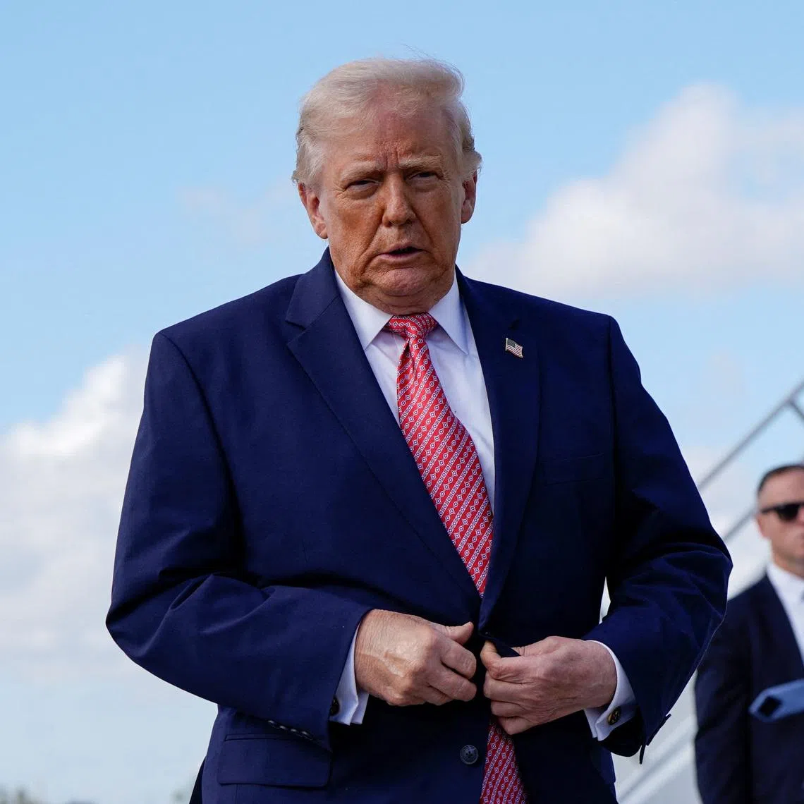 U.S. President Donald Trump walks to speak to reporters as he arrives at Miami International Airport in Miami, Florida, U.S., March 27, 2026. REUTERS/Elizabeth Frantz