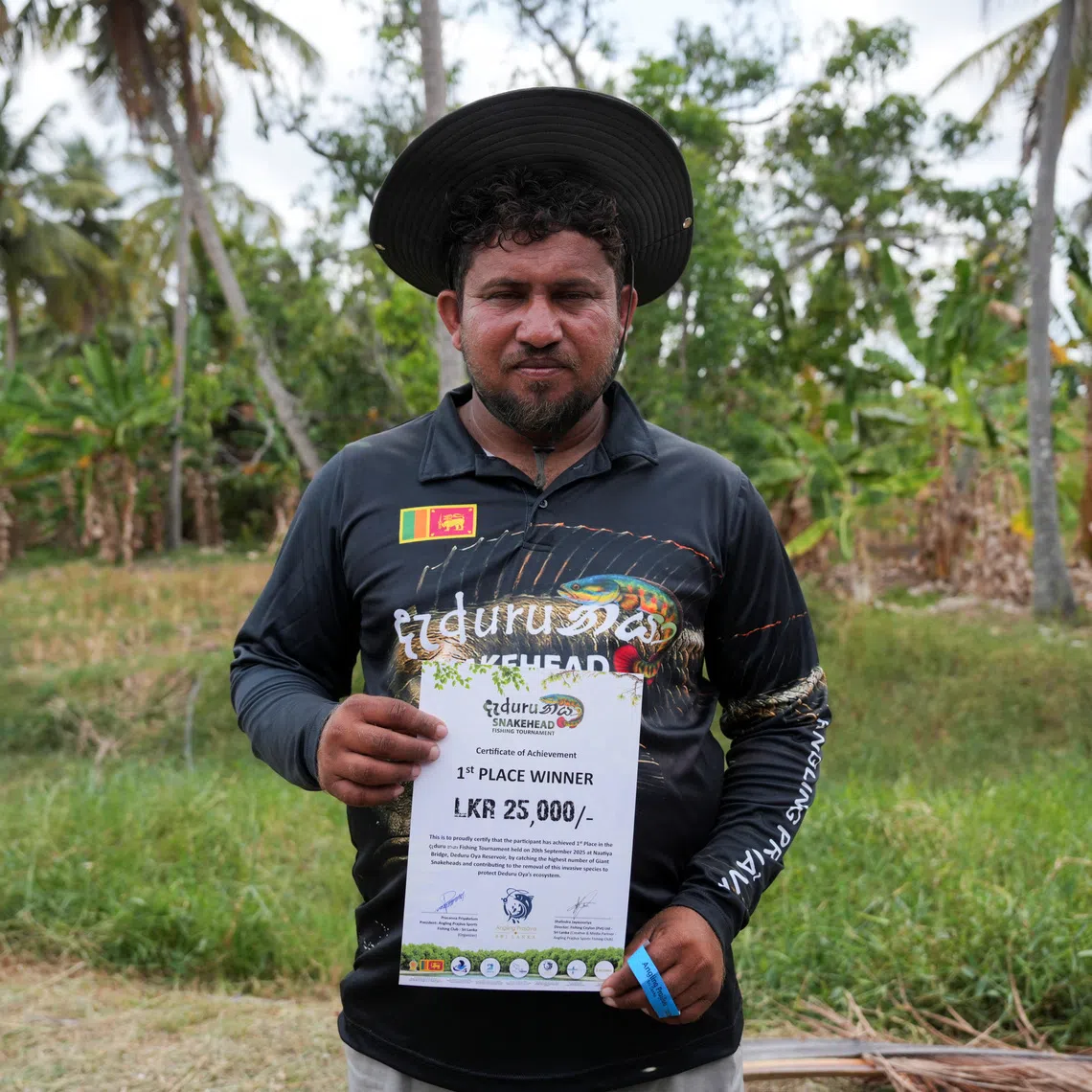 Vimukthi Sandaruwan, 37, winner of the fishing competition, holds his first-place certificate after the prize-giving in Wariyapola, Sri Lanka, September 20, 2025. REUTERS/Thilina Kaluthotage