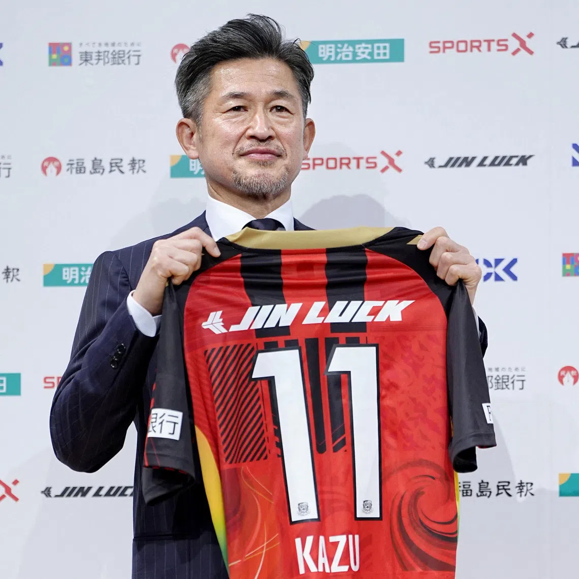 Japan's soccer player Kazuyoshi Miura, 58, known as 'King Kazu', poses for a photograph during his first news conference after joining Fukushima United in the J-League third division in Tokyo, Japan January 9, 2026, in this photo taken by Kyodo. Mandatory credit Kyodo/via REUTERS
