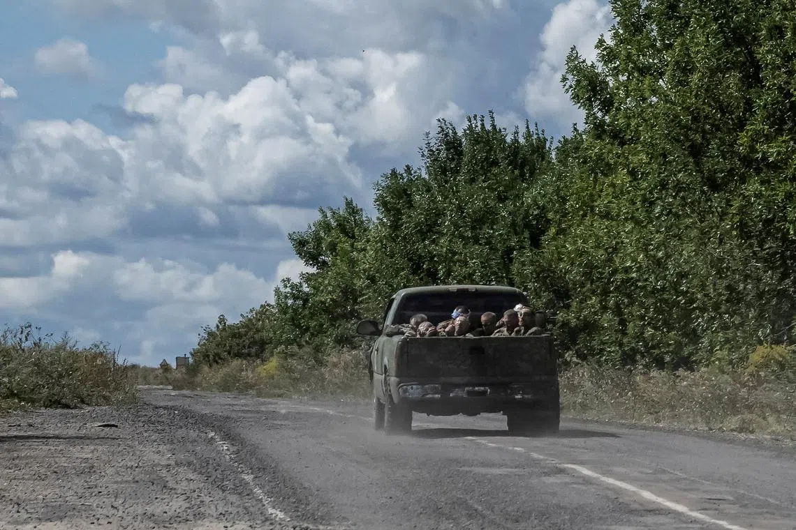 FILE PHOTO: Ukrainian soldiers ride a military vehicle with Russian POWs in the truck bed, amid Russia's attack on Ukraine, near the Russian border in Sumy region, Ukraine August 13, 2024. REUTERS/Viacheslav Ratynskyi/File Photo