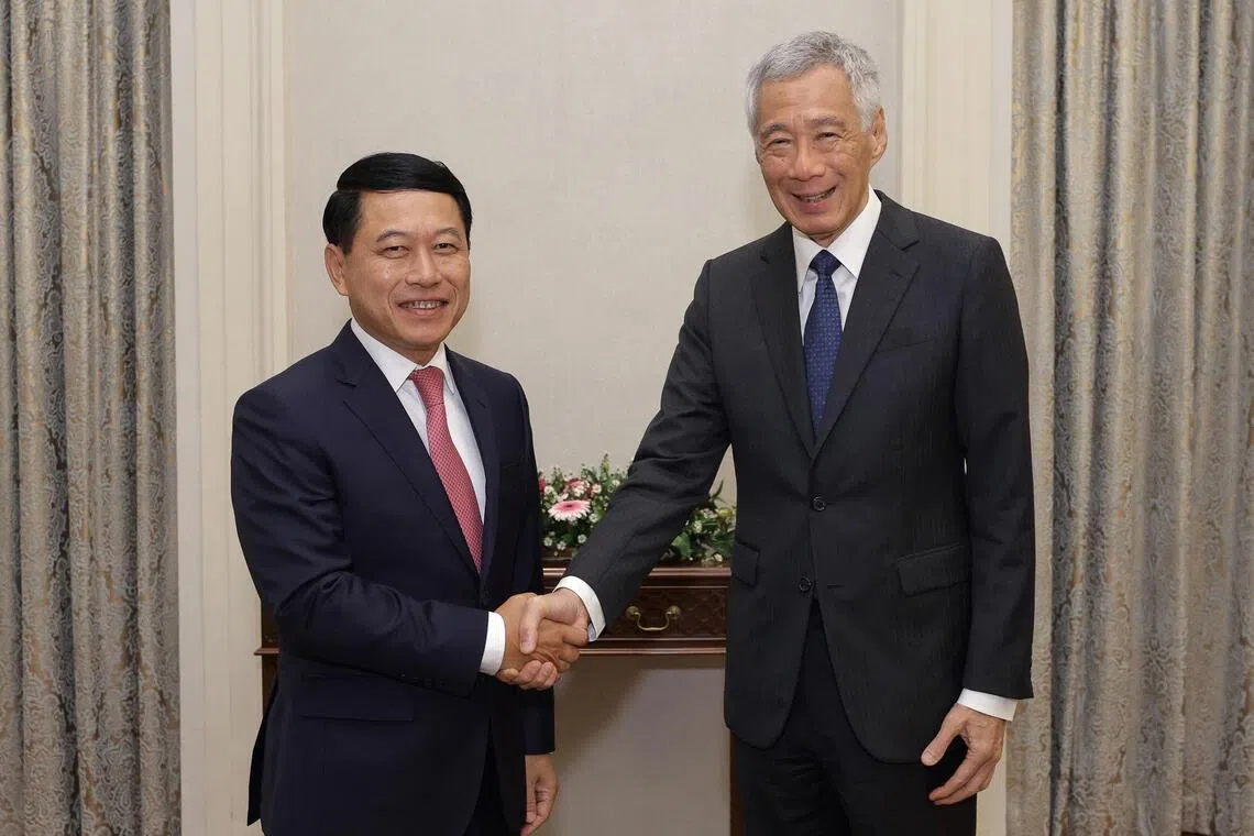 Then Singapore Prime Minister Lee Hsien Loong meets with Saleumxay Kommasith, Laos’ deputy prime minister at the time, on Dec 7, 2023.