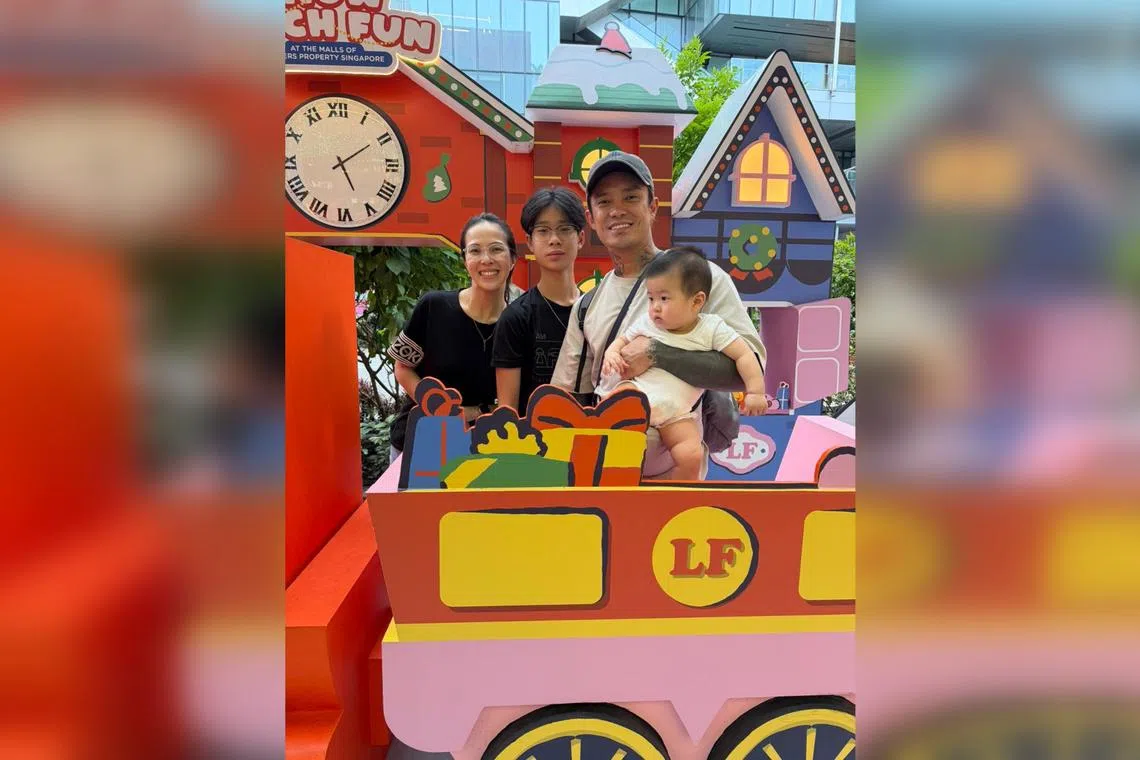 Content creator Simon Khung (second from right), better known as Simonboy, posing with the Christmas displays in Orchard Road with (from left) his wife Chloe Eong; his elder son, Caius, 14; and younger son, 10-month-old Sunny.