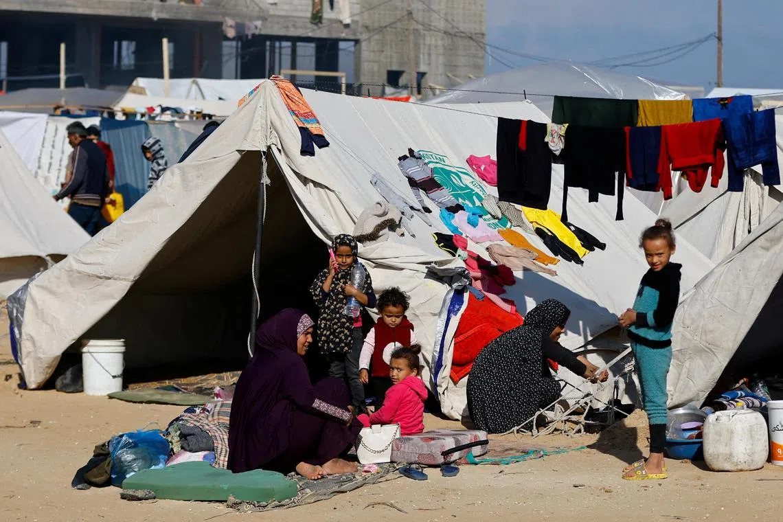 Displaced Palestinians, who fled their houses due to Israeli strike, find shelter at a camp in Rafah, on Dec 6.