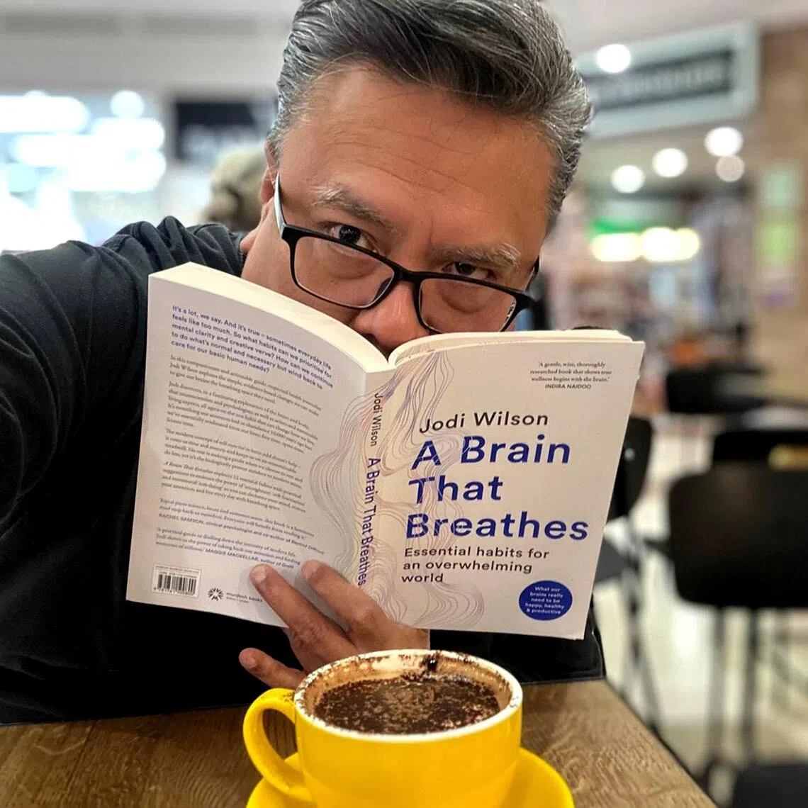 Suhaimi Yusof with A Brain That Breathes, a book he picked up during a trip to Perth.