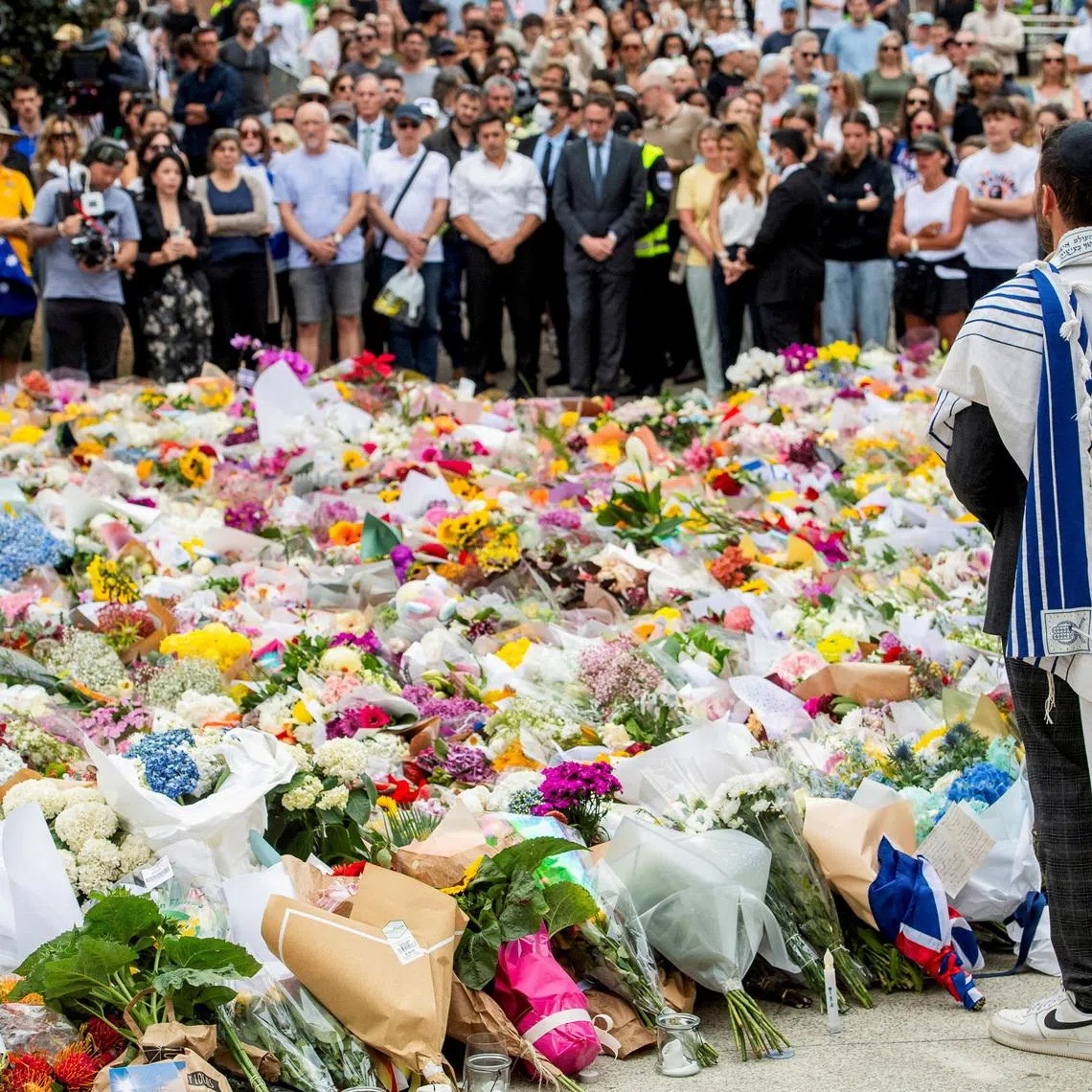 A member of the Jewish community stands at a floral memorial in honour of the victims of the mass shooting targeting a Hanukkah celebration on Sunday, at Bondi Beach, in Sydney, Australia, December 16, 2025. REUTERS/Jeremy Piper