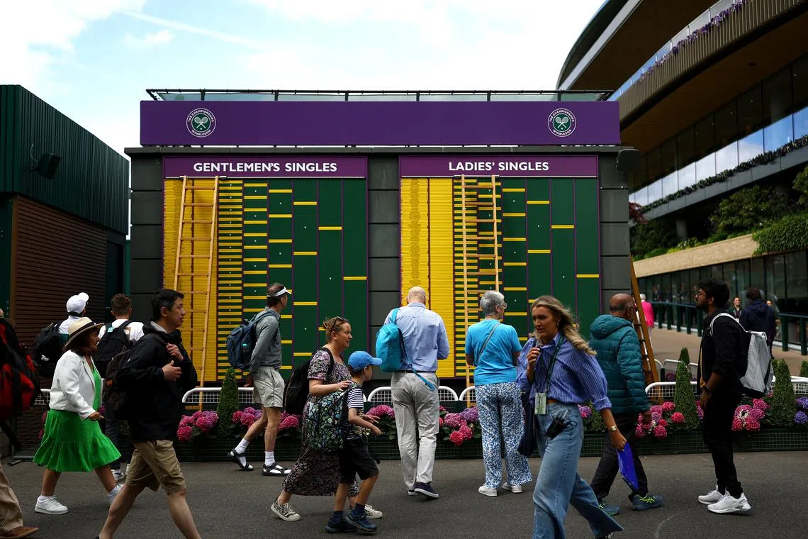 Tennis - Wimbledon - All England Lawn Tennis and Croquet Club, London, Britain - July 1, 2024 General view of spectators and the order of play board before the start of play REUTERS/Hannah Mckay