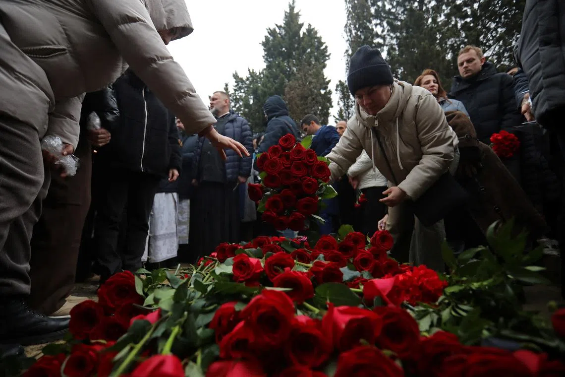 FILE PHOTO: People attend the funeral of Captain Igor Kshnyakin, co-pilot Alexander Kalyaninov and flight attendant Hokuma Aliyeva, crew members of Azerbaijan Airlines Flight J2-8243 that crashed near the Kazakh city of Aktau, in Baku, Azerbaijan December 29, 2024. REUTERS/Aziz Karimov/File Photo