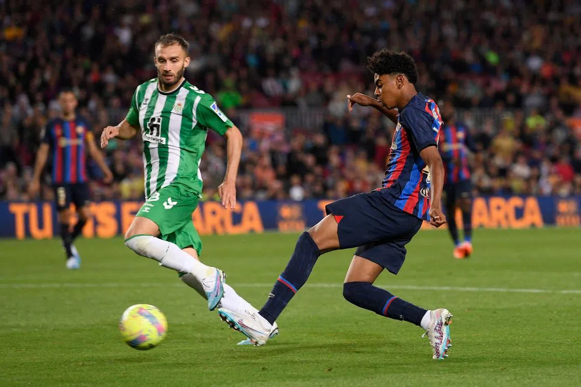 Real Betis' Argentinian defender German Pezzela vies with Barcelona's Spanish forward Lamine Yamal (right) during their La Liga  match on Saturday. 