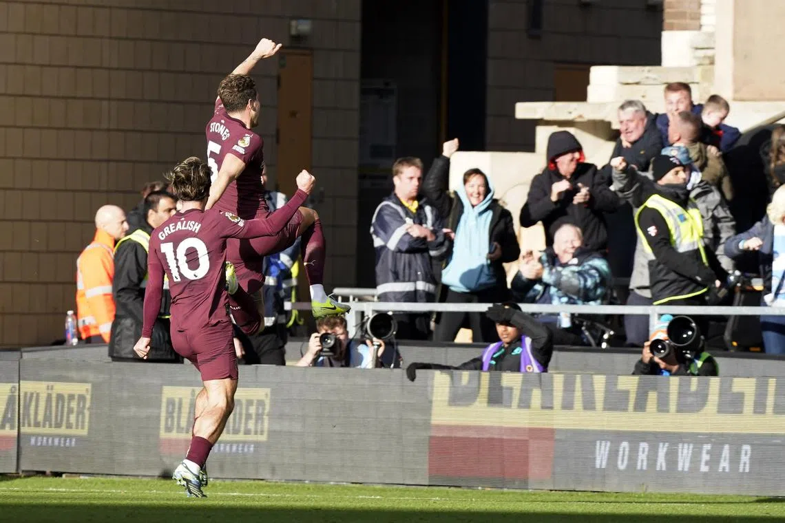 Jack Grealish and John Stones of Manchester City celebrating the winner during the 2-1 English Premier League triumph over Wolverhampton at Molineux on Oct 20.