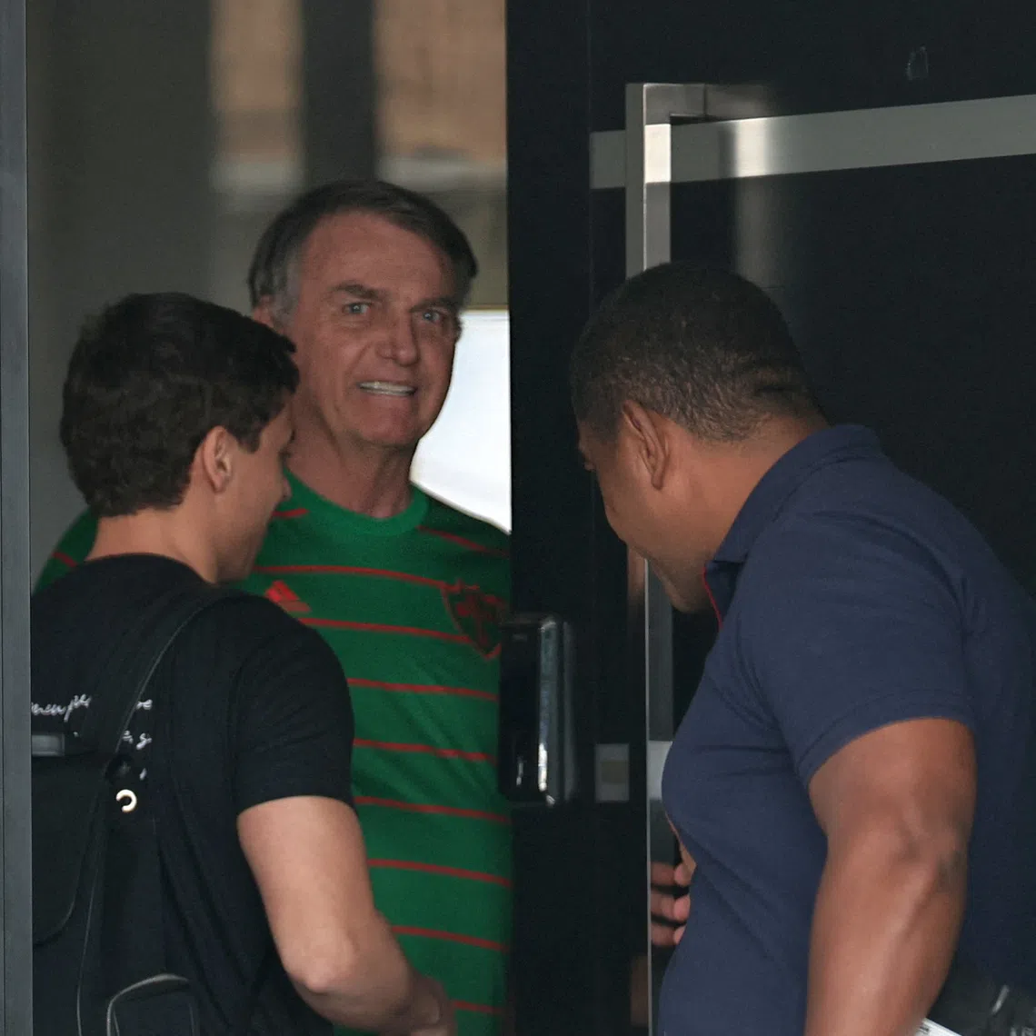 Brazil’s former president Jair Bolsonaro standing in the doorway of his house, during his house arrest, in Brasilia on Nov 21.
