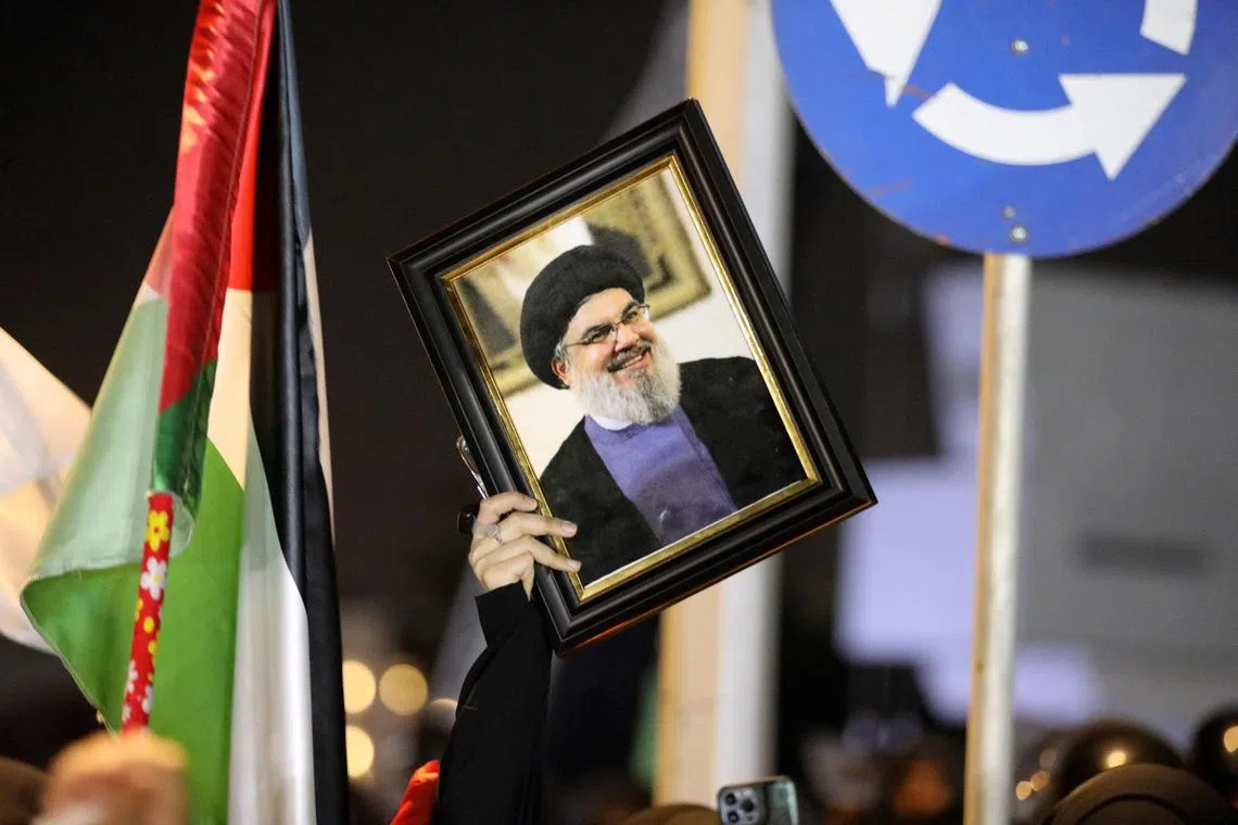 A Hezbollah supporter holding a picture of late Hezbollah leader Hassan Nasrallah, who was killed in an Israeli air strike in Lebanon on Sept 27.