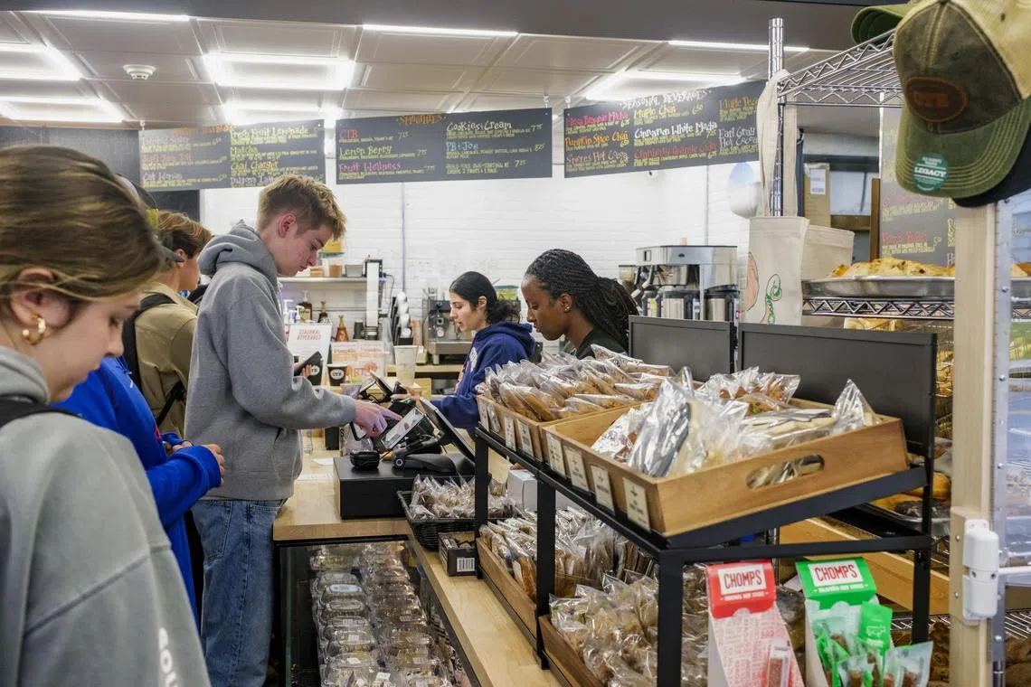 A customer checks out his order at College Town Bagels in Syracuse, N.Y., on Oct. 29, 2024. Economists expect the October data to show unusually weak job creation. But hurricanes and strikes may account for much of the shortfall. (Liam Kennedy/The New York Times)