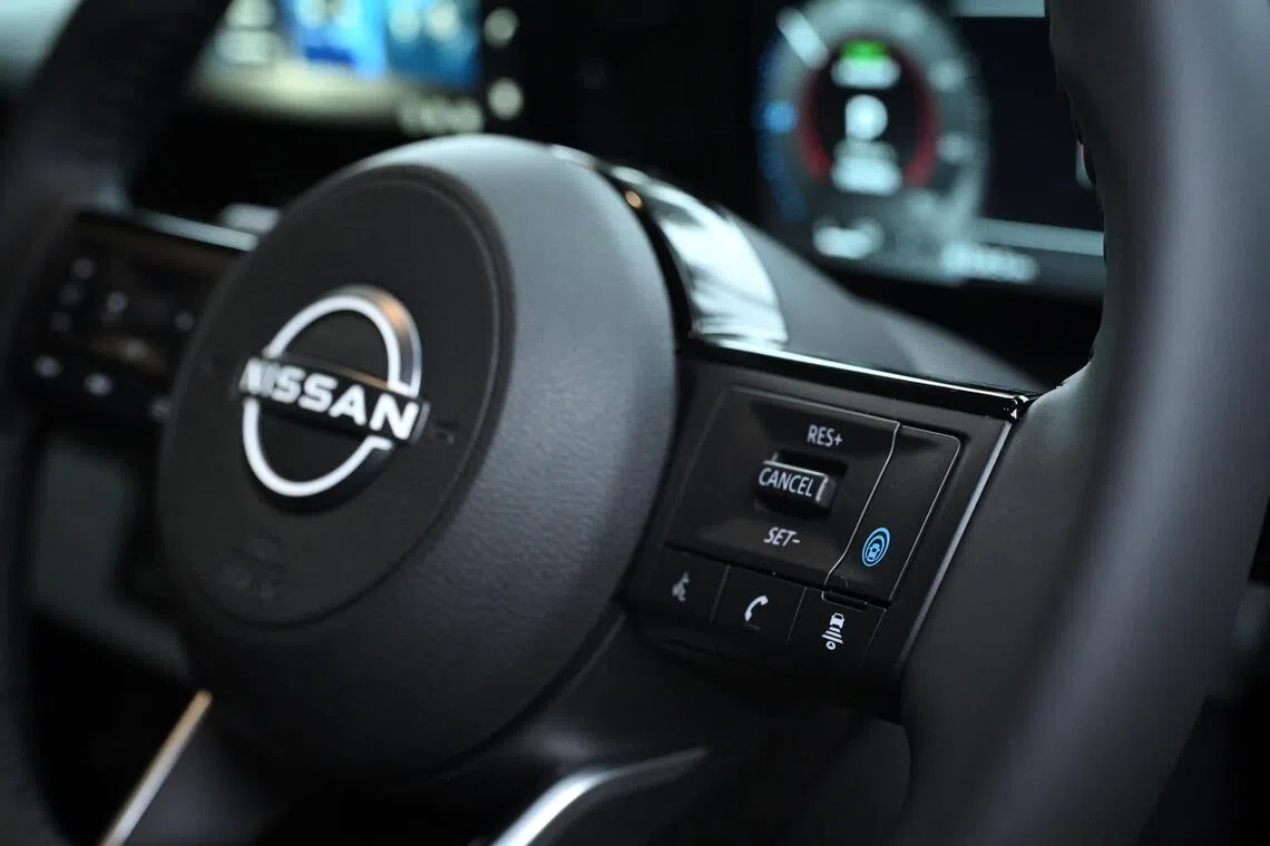 The blue button activates the car’s semi-autonomous driving feature.