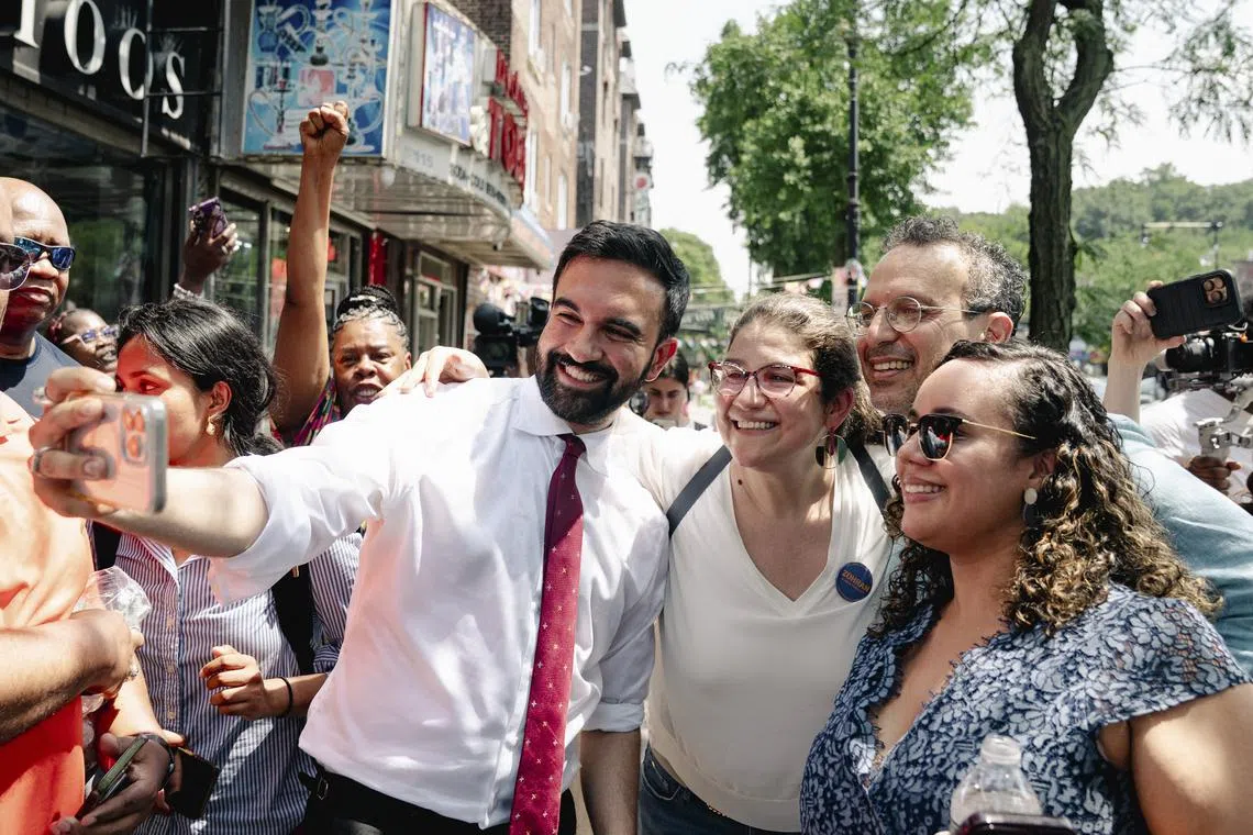 Mr Zohran Mamdani and Councilwoman Carmen De La Rosa (right) take photos with supporters in the Inwood neighborhood of New York on June 23.